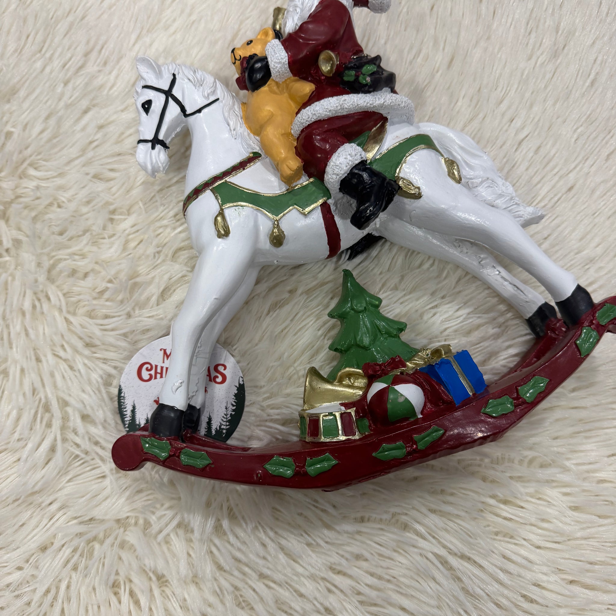 Babbo Natale su cavallo a dondolo